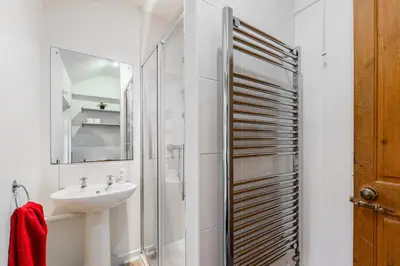 a white bathroom with a sink and a shower at Modern bedrooms-Family -Free Parking-Hi-Speed WiFi-Sleeps 5 in Colchester