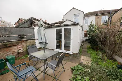 a patio with a table and chairs in a backyard at Modern bedrooms-Family -Free Parking-Hi-Speed WiFi-Sleeps 5 in Colchester