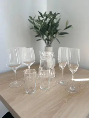 a group of wine glasses and a vase on a table at The Annexe Long Melford in Long Melford