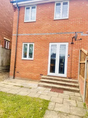 a red brick house with stairs and a door at Pleasant and Homely in Colchester
