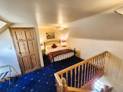 a bedroom with a bed and a wooden door at Thaxted Bed & Breakfast and Accommodation in Thaxted