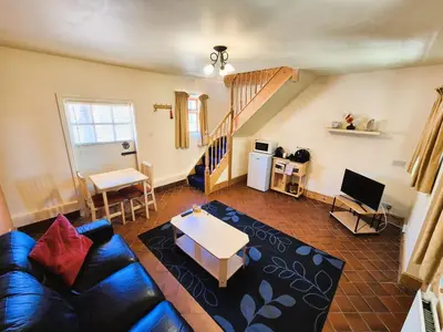 a living room with a couch and a table at Thaxted Bed & Breakfast and Accommodation in Thaxted