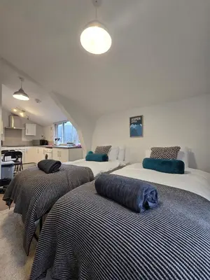 a bedroom with two beds with blankets on them at Canalside 1 bed flat in Hertford