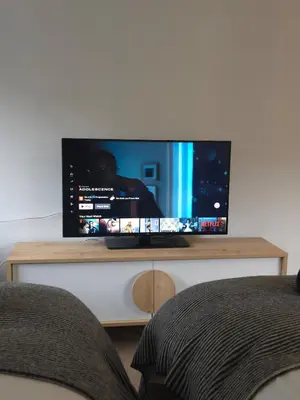 a flat screen tv sitting on top of a table at Canalside 1 bed flat in Hertford