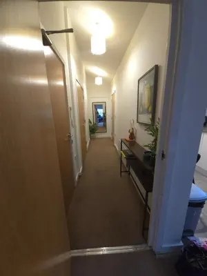 a hallway leading to a room with a hallwaygue at Canalside 1 bed flat in Hertford