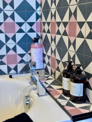 two bottles ofodorizers sitting on a bathroom sink at Quaint Bury St Edmunds Cottage in Bury Saint Edmunds