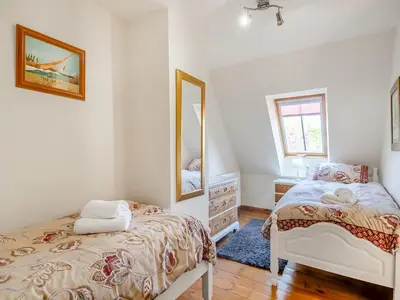 a bedroom with a bed and a mirror at Chestnut Tree Barn in Saint Lawrence
