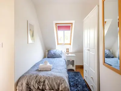 a small bedroom with a bed and a mirror at Chestnut Tree Barn in Saint Lawrence