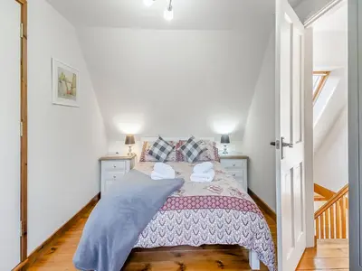 a bedroom with a bed with a pink blanket at Chestnut Tree Barn in Saint Lawrence