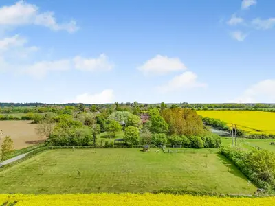 an aerial view of a large grassy field with trees at Treetops - Uk49523 in Saint Lawrence
