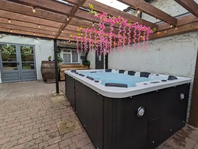 a hot tub in the middle of a patio at A historic Pub with a modern twist - The Greyhound in Bury Saint Edmunds