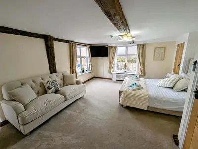 a living room with a couch and a bed at A historic Pub with a modern twist - The Greyhound in Bury Saint Edmunds