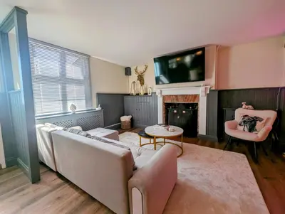 a living room with a couch and a tv at A historic Pub with a modern twist - The Greyhound in Bury Saint Edmunds