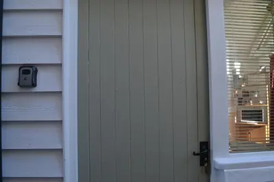 a door with a window on the side of a house at The White Barn near Cambridge in Huntingdon