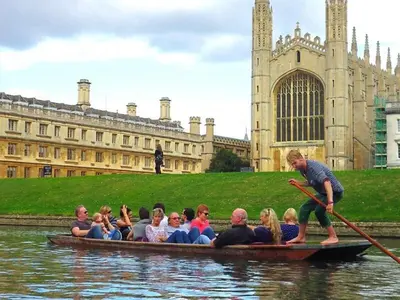 a group of people in a boat in the water at The White Barn near Cambridge in Huntingdon