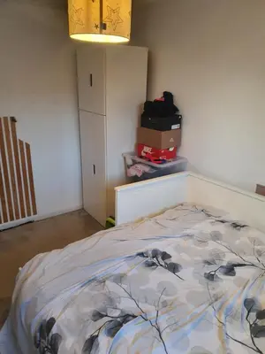 a bedroom with a bed in a room with boxes at One bed room in three bed room house in Hoddesdon