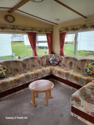 a living room with a couch and a coffee table at Home from home in Holland-on-Sea