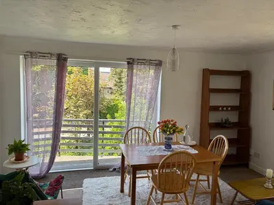 a dining room with a table and chairs and a window at Next to double Nobel Laureate in Trumpington