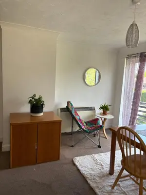 a living room with a chair and a table at Next to double Nobel Laureate in Trumpington