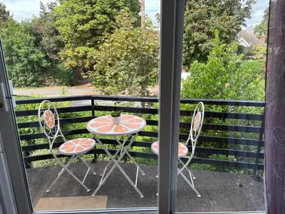 a window with a table and chairs on a balcony at Next to double Nobel Laureate in Trumpington