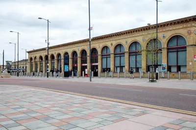 a large building with a street in front of it at Stylish and Modern Flat with Free Parking Pass the Keys in Cambridge