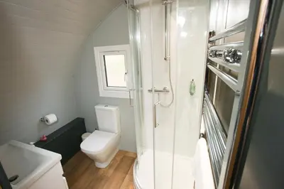 a small bathroom with a toilet and a shower at All Manor Of Events - Glamping Pods in Henley