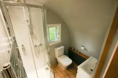 a small bathroom with a toilet and a shower at All Manor Of Events - Glamping Pods in Henley