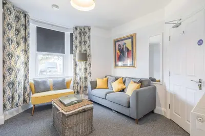 a living room with a couch and a chair at Modern 4-Bedroom Detached Home in Central Cambridge with Parking in Cambridge