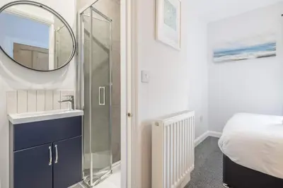 a bathroom with a sink and a mirror at Modern 4-Bedroom Detached Home in Central Cambridge with Parking in Cambridge