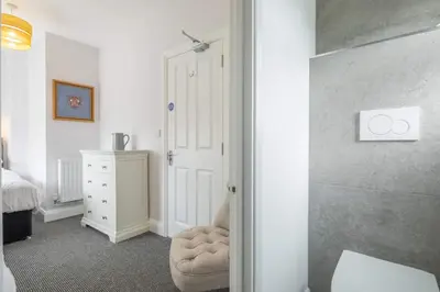 a bedroom with a white door and a white dresser at Modern 4-Bedroom Detached Home in Central Cambridge with Parking in Cambridge