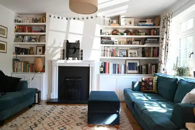 a living room with a couch and a fireplace at The Avenue in Cherry Hinton