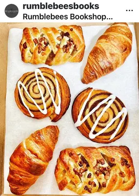a bunch of pastries sitting on a cutting board at Upstairs at Rumblebees in Felsted Station