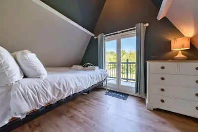 a bedroom with a bed and a window at The Folly, Thorpe Forest in Brettenham