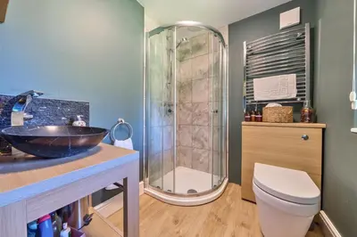 a bathroom with a sink and a shower and a toilet at The Folly, Thorpe Forest in Brettenham