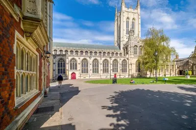 a large building with a tower and a church at Tower Cottage - Medieval Grid Townhouse in Bury Saint Edmunds
