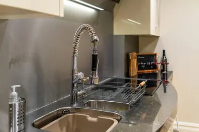 a kitchen counter with a sink and a faucet at Tower Cottage - Medieval Grid Townhouse in Bury Saint Edmunds