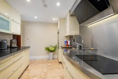 a kitchen with a sink and a counter top at Tower Cottage - Medieval Grid Townhouse in Bury Saint Edmunds