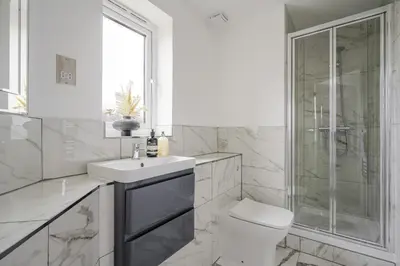 a bathroom with a toilet and a sink and a shower at 2 Luxurious Apartments with Free Parking near Chelmsford City in Chelmsford