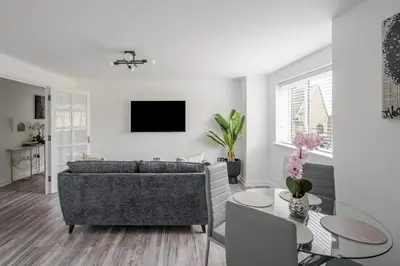 a living room with a couch and a table at 2 Luxurious Apartments with Free Parking near Chelmsford City in Chelmsford