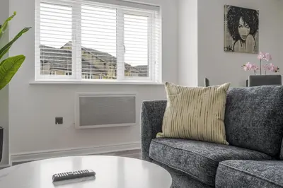 a living room with a couch and a table at 2 Luxurious Apartments with Free Parking near Chelmsford City in Chelmsford