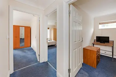a room with a bedroom with a bed and a television at Spacious 3 bed flat in Colchester - Free parking in Hythe