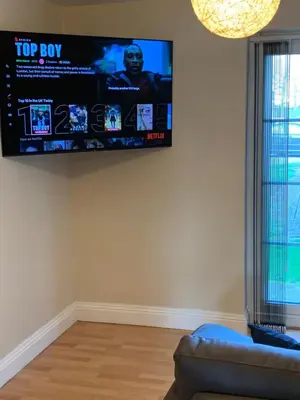 a living room with a flat screen tv on the wall at Two Bed Flat By The Beach No Parties No Events in Southend-on-Sea