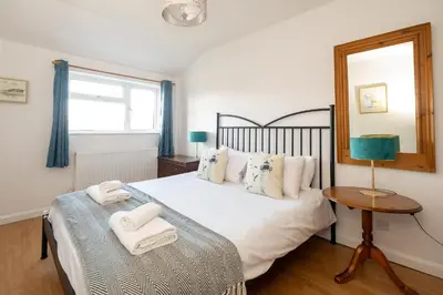 a bedroom with a bed with towels on it at 7 The Plantation - Aldeburgh Coastal Cottages in Aldeburgh