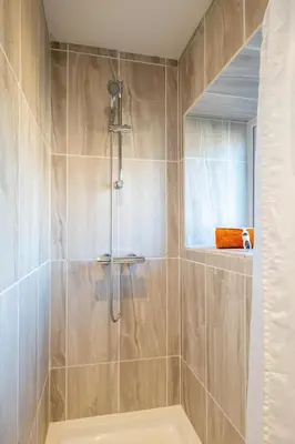 a bathroom with a shower and a tub at 7 Coastguards Cottages - Aldeburgh Coastal Cottages in Aldeburgh