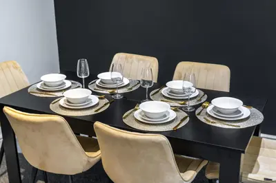 a black table with chairs and plates and wine glasses at Modern Comfort 4BR Home for 10 in North Weald