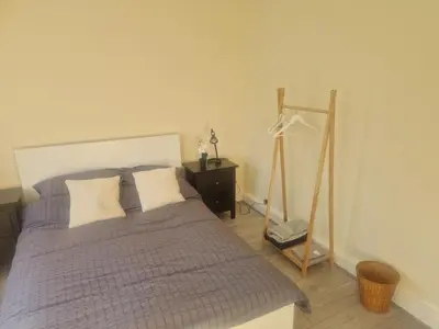 a bedroom with a bed and a dresser and a mirror at Arundel Road, RM30RX in Harold Wood