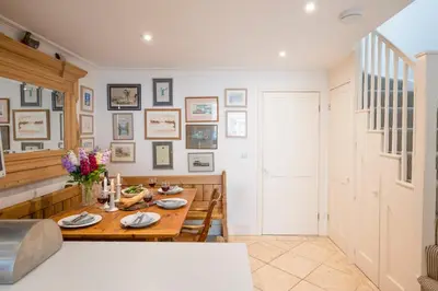 a dining room with a wooden table and chairs at 207 High Street, Aldeburgh in Aldeburgh