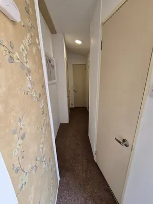 a hallway with a door with flowers painted on it at FI005 Loomy Escapes Caravan at St Osyth Beach Essex in Saint Osyth