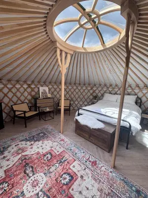 a room with a bed and a window in a yurt at The Skye Yurt in Messing