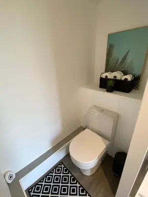 a small bathroom with a toilet and a shelf at The Skye Yurt in Messing